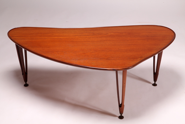 Kidney shaped coffee table with tripod legs in teak